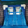 Interior view of Island Drop Dual Lane Commercial Inflatable Combo (Wet/Dry) showing two blue inflatable slides side by side. The slides are flanked by brown inflatable palm tree pillars with textured bark design. A blue inflatable base and teal-colored top frame are visible. The image captures the inside of the inflatable structure, showcasing its dual-lane design.