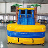 Front view of Lava Falls Dual Lane Commercial Inflatable Combo showing dual blue water slides emerging from an orange and yellow volcano-themed structure. Inflatable palm trees flank the sides, and a blue bounce house area is visible. The inflatable is set against a white background, highlighting its tropical volcano design for commercial wet/dry use.