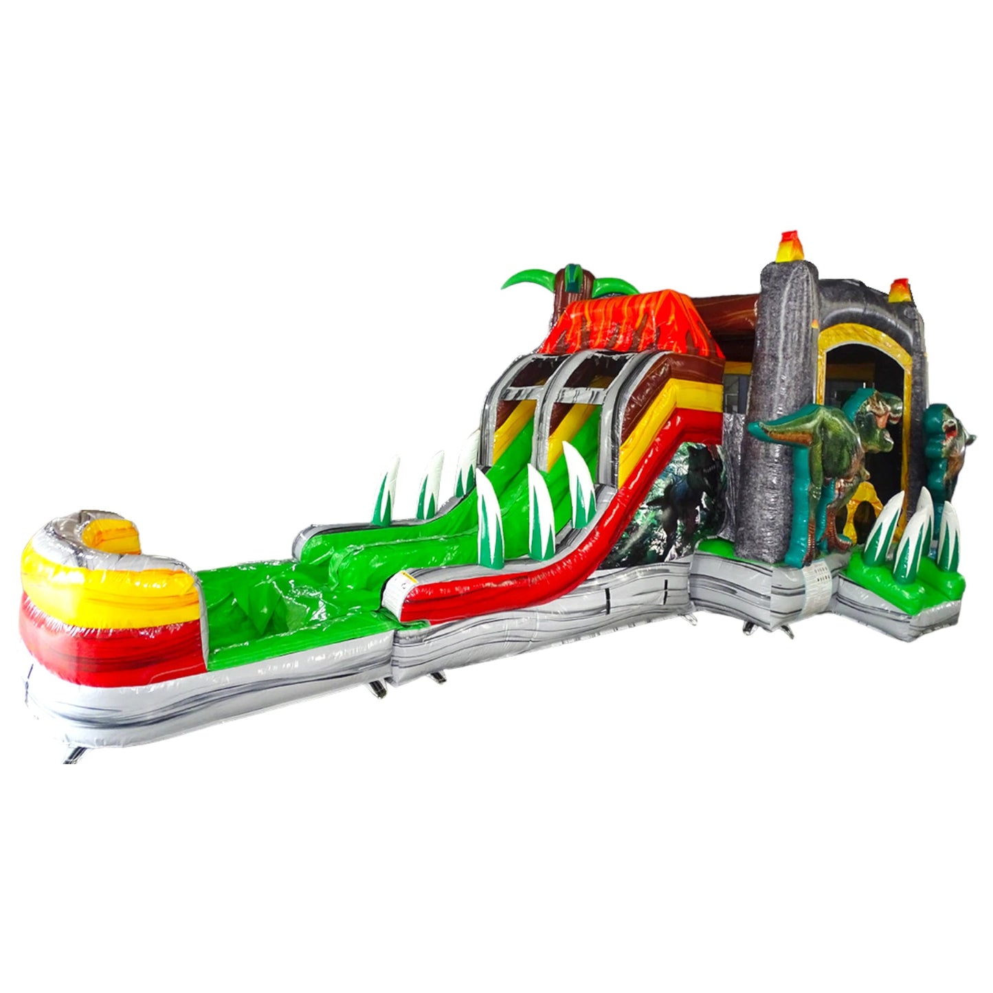 Side view of Lava Raptor Dual Lane Commercial Inflatable Combo isolated on a white background. The inflatable features dual slides, a brown volcano structure with orange lava designs, and realistic dinosaur figures. Palm tree accents and a colorful splash pool area are visible, showcasing its prehistoric theme for commercial wet/dry use.