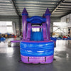 Front view of Mystic Castle Commercial Econo Inflatable Combo (Wet/Dry) showing the bounce house entrance with purple turrets and blue frame. Interior visible through mesh windows. Set up in an indoor warehouse with concrete flooring, showcasing its vibrant colors and castle-like design.