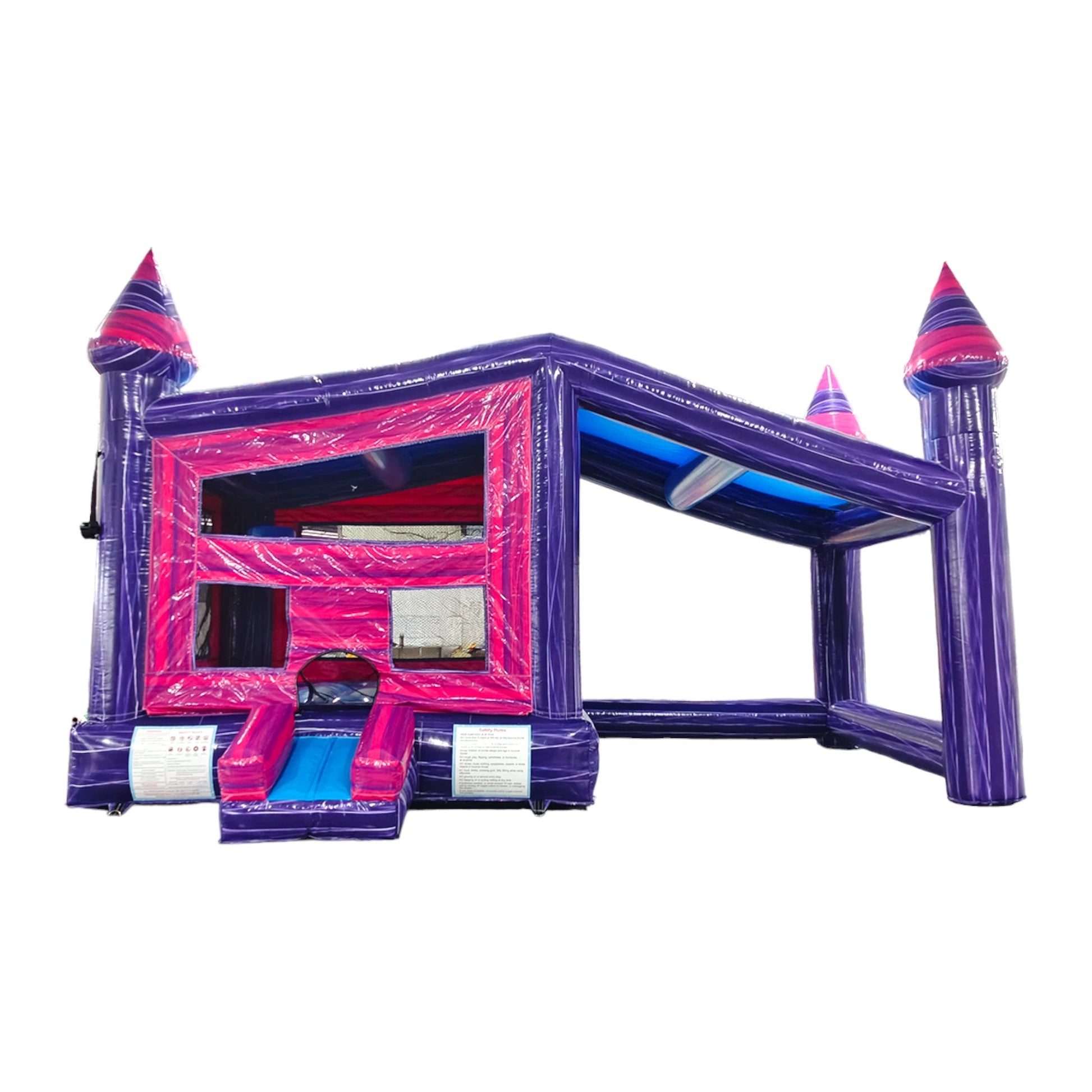 Front view of Purple Palace Commercial Grade Canopy Bounce House featuring vibrant purple walls and pink accents. The inflatable structure has four tall purple towers with pink conical tops, a pink entrance, and mesh windows. A small slide protrudes from the front. Set against a white background, showcasing its castle-like design for commercial use.