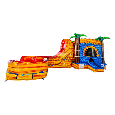 Side view of Rasta Curved Dual Lane Commercial Inflatable Combo (Wet/Dry) featuring vibrant tropical colors. Large inflatable structure with dual curved slides in red and orange, leading to a spacious splash pool. Blue castle-like entrance with palm tree decorations. Set against a white background, showcasing its colorful design and wet/dry functionality.