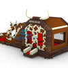 Front view of Rodeo Rush Dual Lane Commercial Inflatable Combo set up in a large indoor warehouse. The inflatable features a brown base with cow print patterns, a bull-shaped figure with slides, and a bounce house area. Large white horns top the structure, and "RODEO RUSH" is visible. Metal roofing and various other inflatable products are visible in the background.