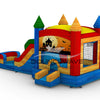 back view of Seasonal Sampler Commercial Econo Inflatable Panel Combo showcasing a Halloween-themed panel with a haunted house, ghost, and jack-o'-lanterns against an orange sky. The inflatable structure features colorful towers, dual slides in red and blue, and a bounce house area with mesh windows. Set on a blue base with yellow steps leading to the entrance.
