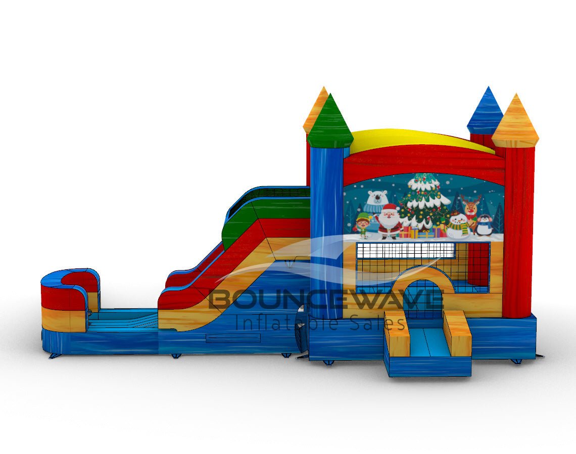 side view of Seasonal Sampler Commercial Econo Inflatable Panel Combo showcasing a Christmas-themed panel with Santa Claus, snowmen, penguins, and other festive characters against a snowy background. The inflatable structure features colorful towers, dual slides in red and green, and a bounce house area with mesh windows. Set on a blue base with yellow steps leading to the entrance.
