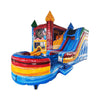 Large inflatable combo featuring a colorful bounce house with patriotic theme, attached slide, and splash pool. The structure has red, white, and blue colors with star and firework decorations. Set up in an indoor warehouse with metal roofing and other inflatable products visible in the background.