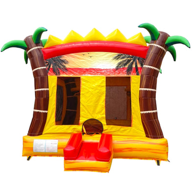 Tropical-themed inflatable Summer Sizzler Commercial Grade Bounce House featuring a vibrant design with two large inflatable palm trees flanking a yellow bounce area. The structure has a red curved top with yellow spikes resembling a sun, brown palm tree trunks, and green palm fronds. The entrance has a small red slide and step. A sunset scene with palm tree silhouettes is printed on the back wall. Set against a white background.