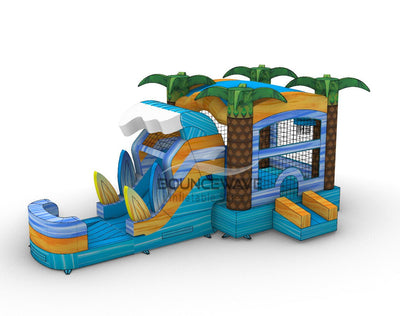 Side view of Surf's Up Commercial Econo Inflatable Combo (Wet/Dry) highlighting the curved wave-shaped slide, bounce house structure, and inflatable palm trees. The combo includes surfboard decorations, mesh windows, and a blue base with yellow accents. Set up on a white background, showcasing its wet/dry functionality.