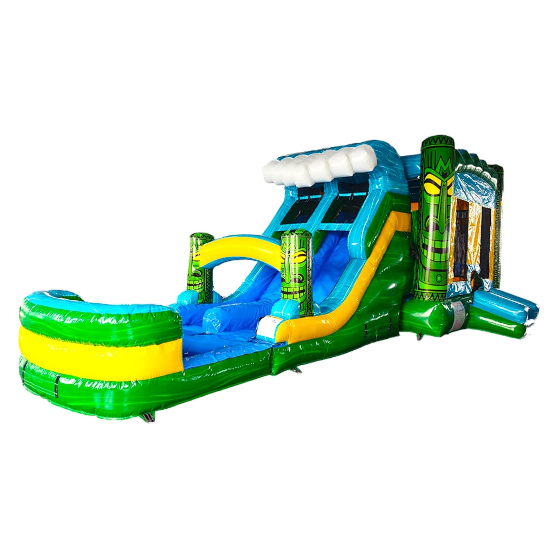 Side view of Tiki Wave Dual Lane Commercial Inflatable Combo featuring a tropical theme with green tiki-style pillars. The structure has dual slides, one blue and one yellow, emerging from a blue wave-like top. A large splash pool area with green and yellow stripes is visible at the base. Set against a white background, showcasing its design for commercial wet/dry use.