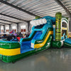 Side view of Tiki Wave Commercial Econo Inflatable Combo (Wet/Dry) showcasing the large blue curved slide with white inflatable wave crest, yellow bounce house structure, and green tiki face pillars. The combo includes a splash pool area and is set against a white background, highlighting its tropical theme and wet/dry functionality.